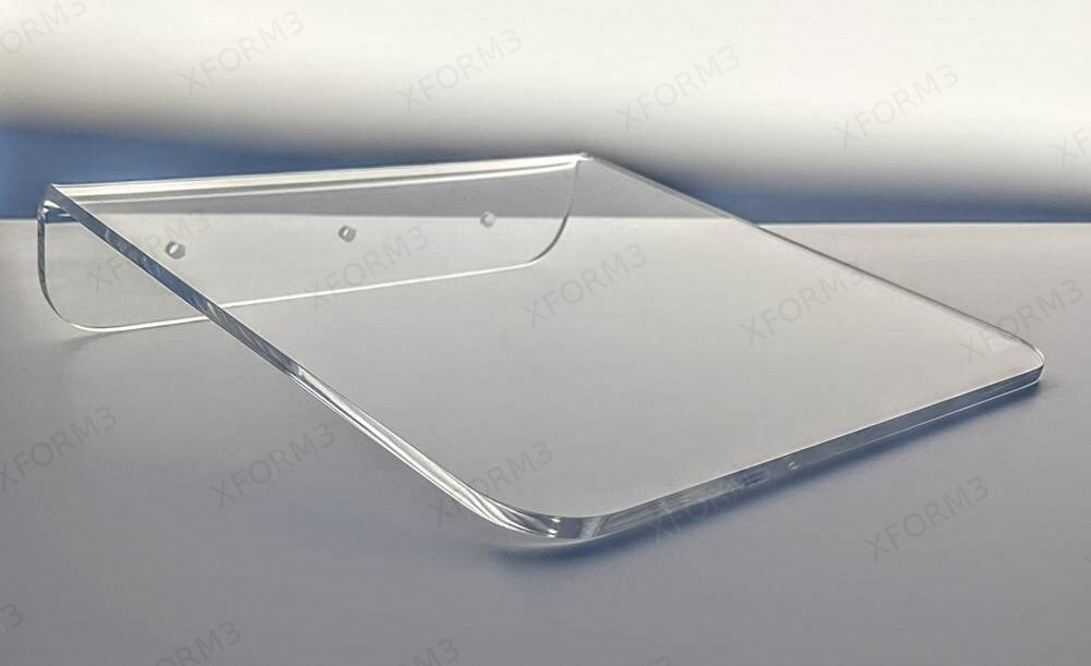 Close view of a rounded clear acrylic shelf and its rear mounting lip