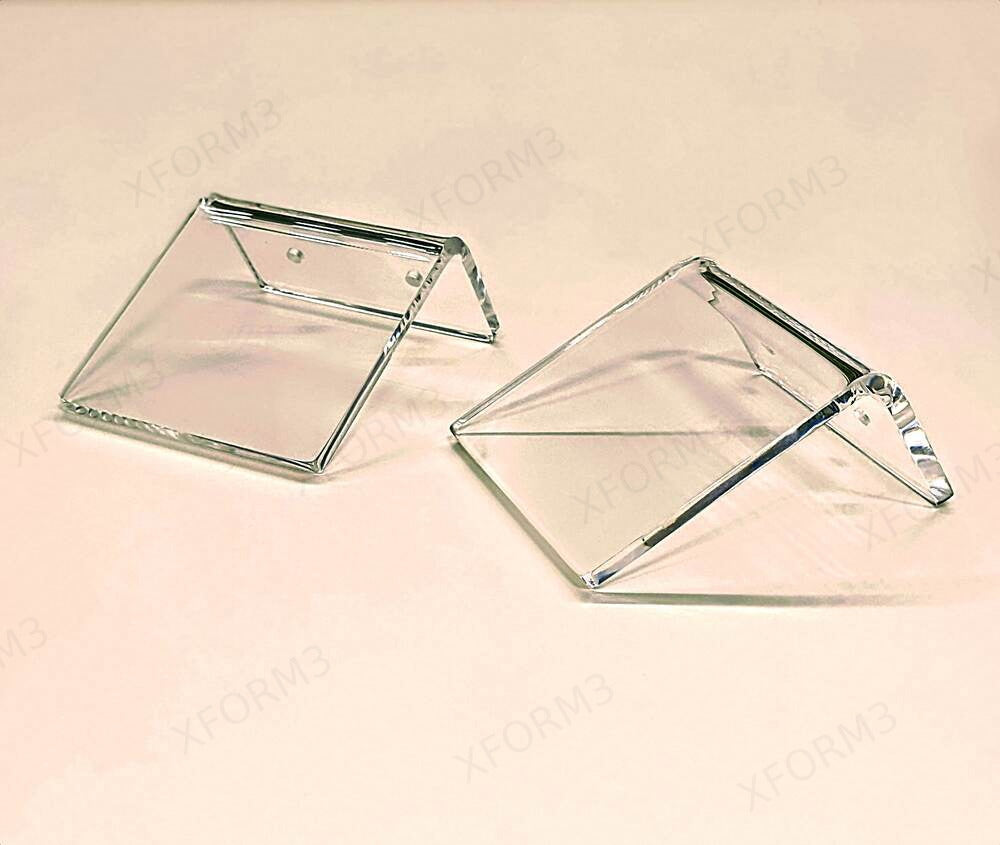 Two compact clear acrylic shelves showing their shape and rear mounting lips