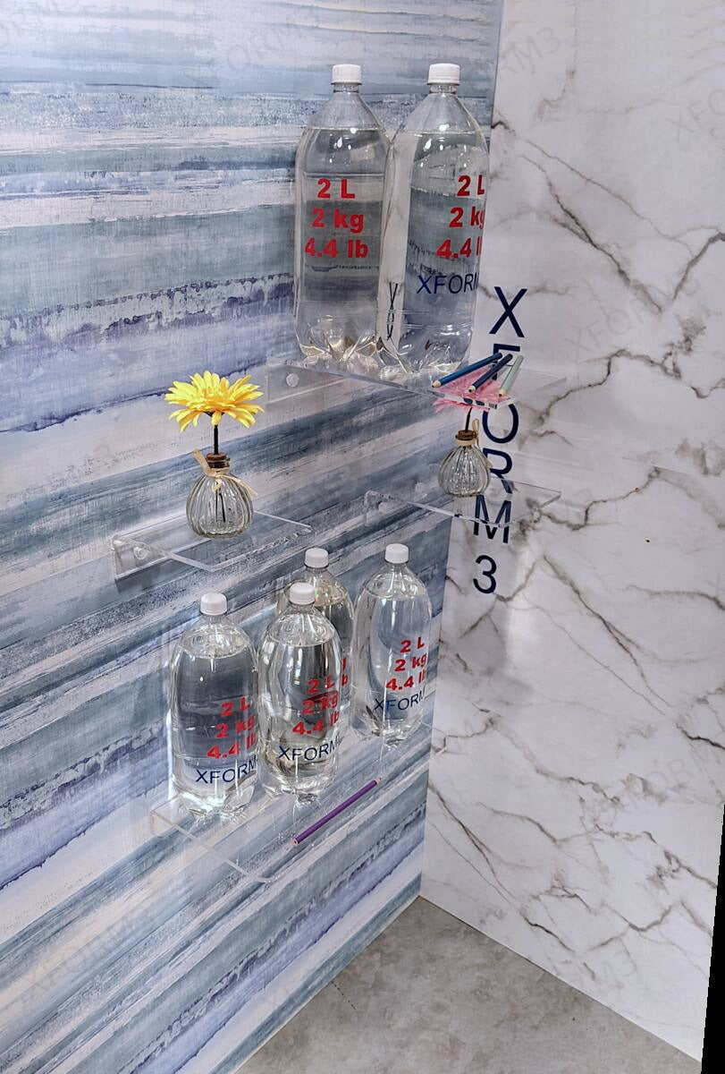 Multiple clear wall shelves photographed with flowers and water bottles
